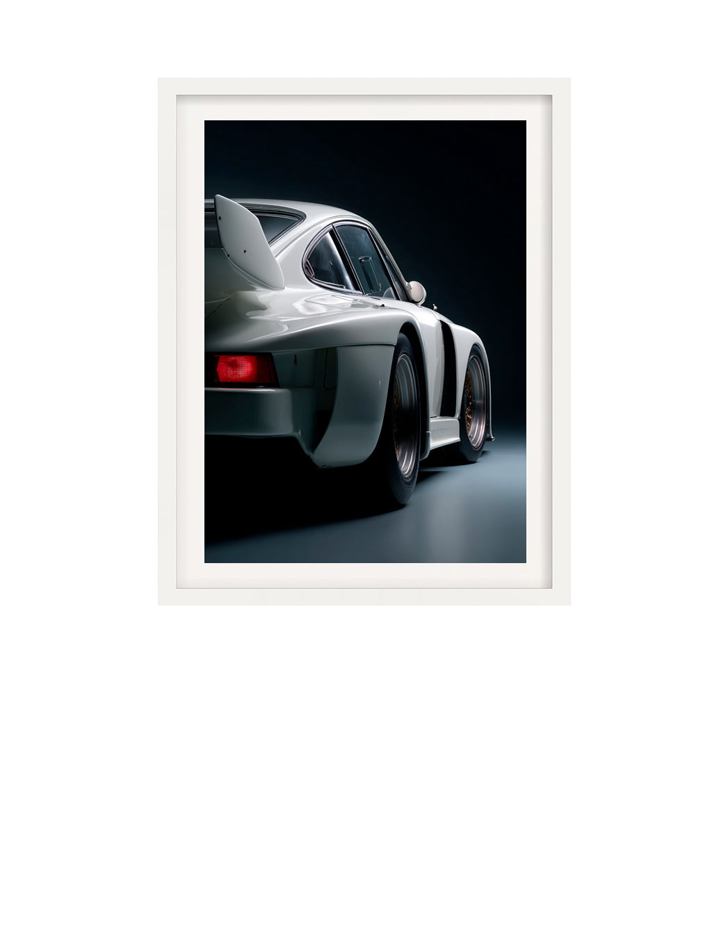 Framed photograph of a white 1980 Porsche 935 sports car on a black background