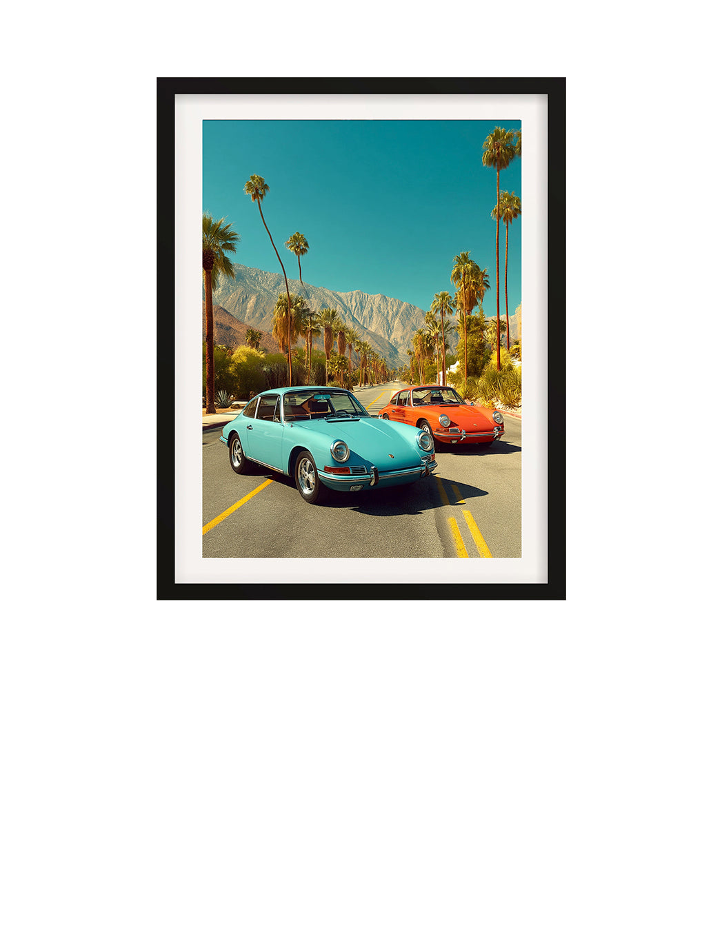 Two vintage 9111T Porsche cars parked on a road with palm trees and mountains in the background.