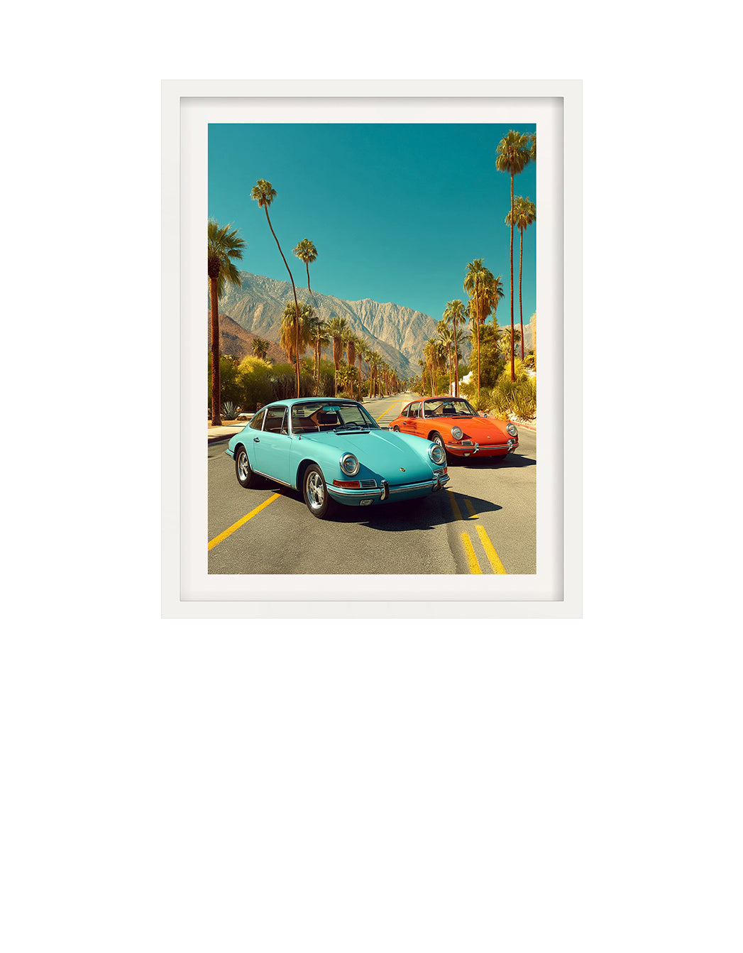 Two vintage 9111T Porsche cars parked on a road with palm trees and mountains in the background.