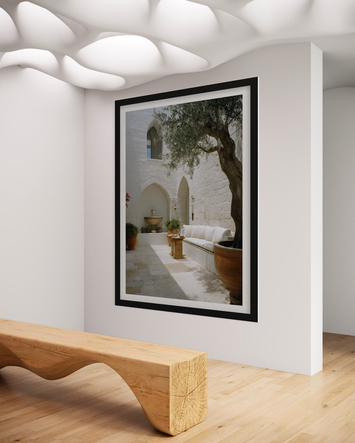 Olive Courtyard Mediterranean wall art featuring a sunlit white stone courtyard, mature olive tree, arched architecture and neutral outdoor seating.
