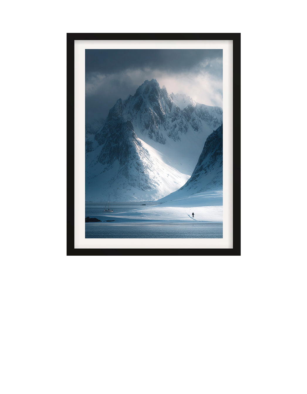 Framed photograph of a snowy mountain landscape with a person standing at the base.