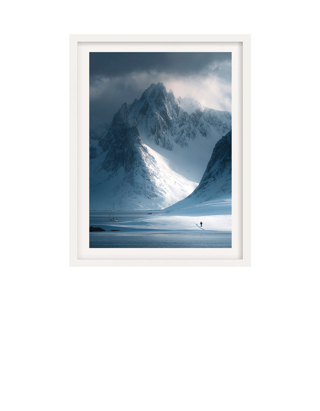 Framed photograph of a snowy mountain landscape with a person standing at the base.