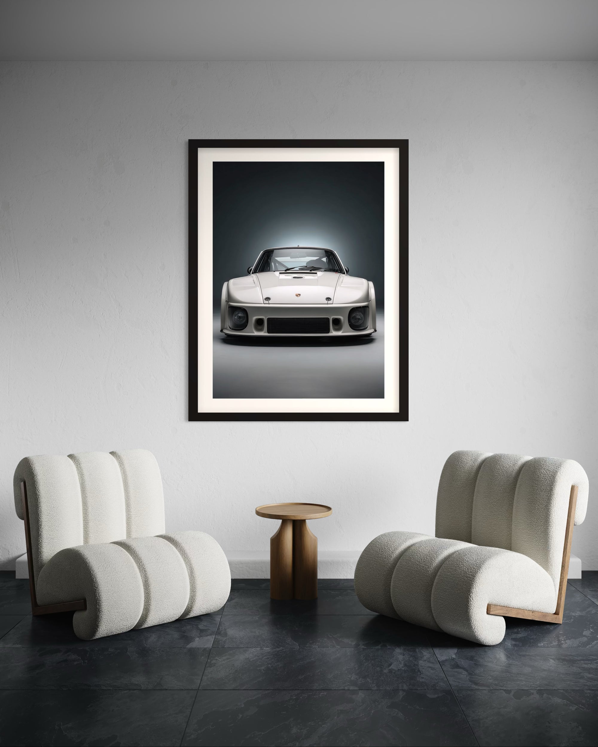 Framed artwork of a classic 1980 Porsche 935 car in a modern living room with two stylish chairs.
